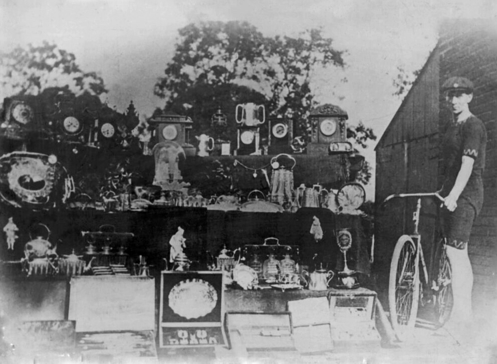 image of Jospeh Armstrong with his impressive array of cycling prizes - 1920